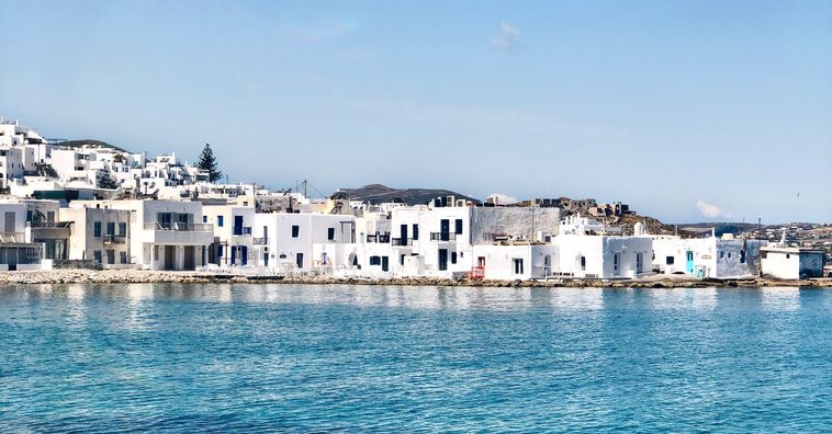 white buildings along the coast in greece on a sunny day