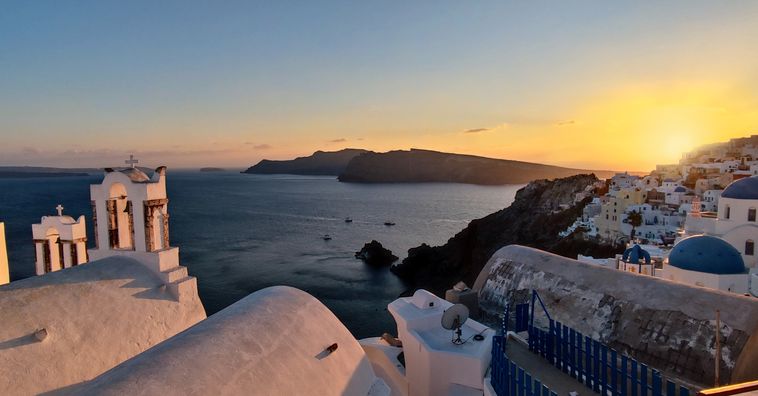 blue domed buildings in greece at sunset