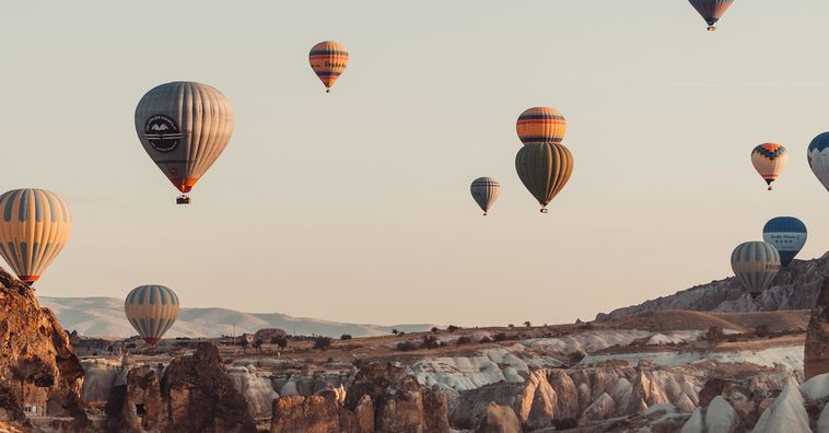hot air balloons floating in the air at sunset in cappadocia turkey