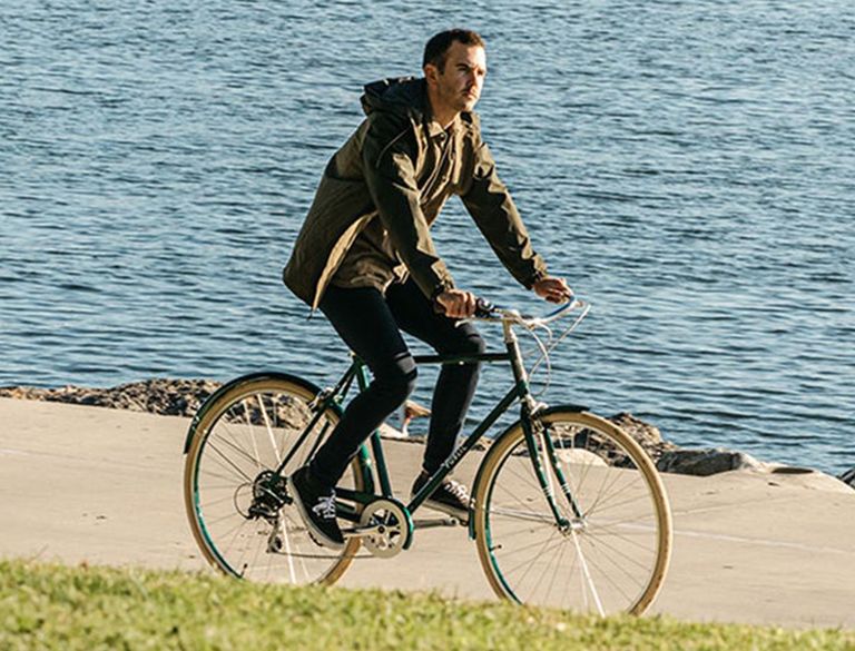 Man cycling along the coastline on his PUBLIC Bike