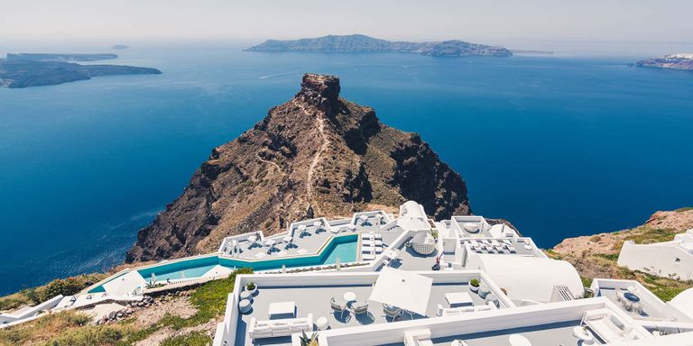 Imerovigli Village in Santorini. Terraces and pools with view to Skaros Rock and the Aegean Sea.