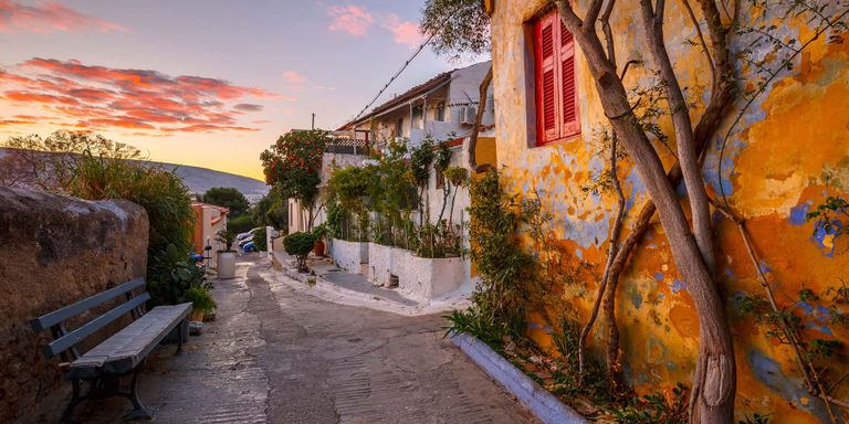 Narrow walkways and staircases of Anatiofika, a quaint colorful village in Athens, Greece.