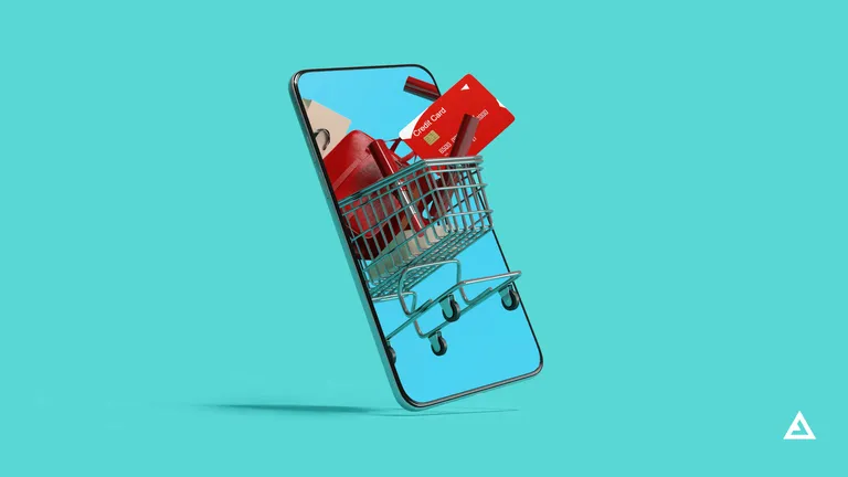 A shopping cart filled with goods and a credit card emerge from a mobile phone screen.