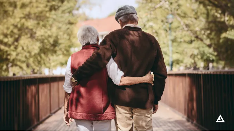An old couple walking hand in hand