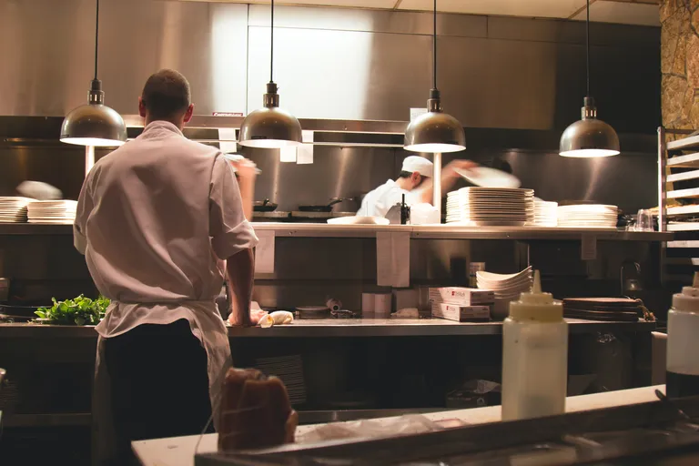 Two BOH staff working in a restaurant's kitchen