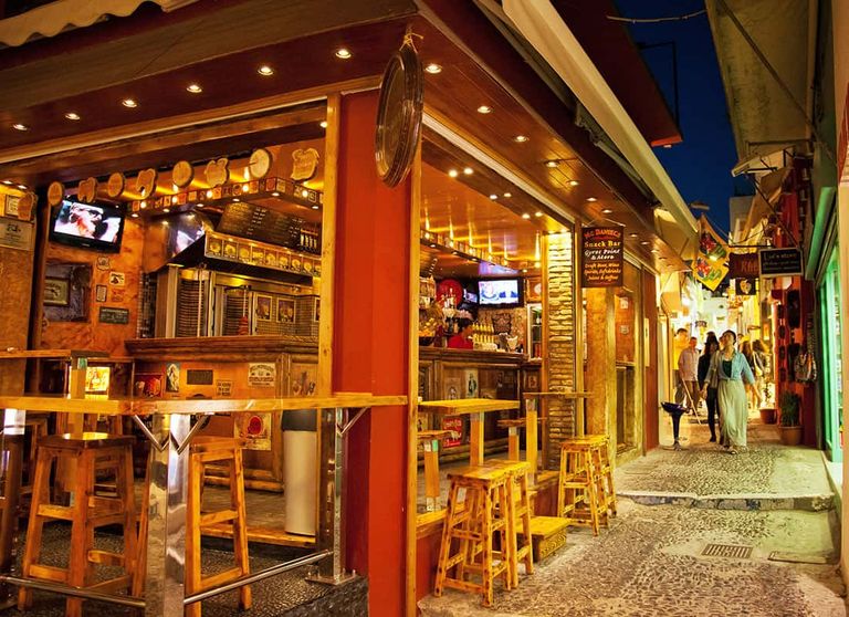 A bar and restaurant in Fira Town, Santorini at nighttime.
