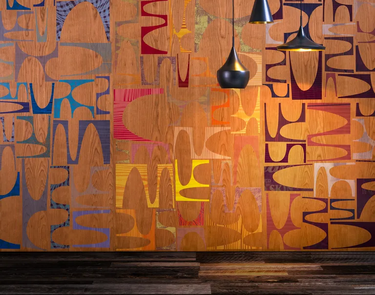 Several black lamps hang over in front of a colorful patterned Infused Veneer paneled wall.