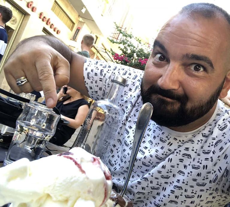 EF Ultimate Break Tour Director Kyriakos enjoys dessert at Nancy's Sweet Home in Athens, Greece.