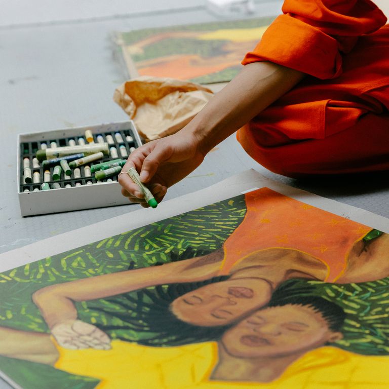 Artist Sola Oluloede hand-finishing her print in her studio - close up