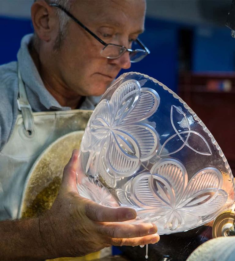 An Irish craftsman sculpting glass