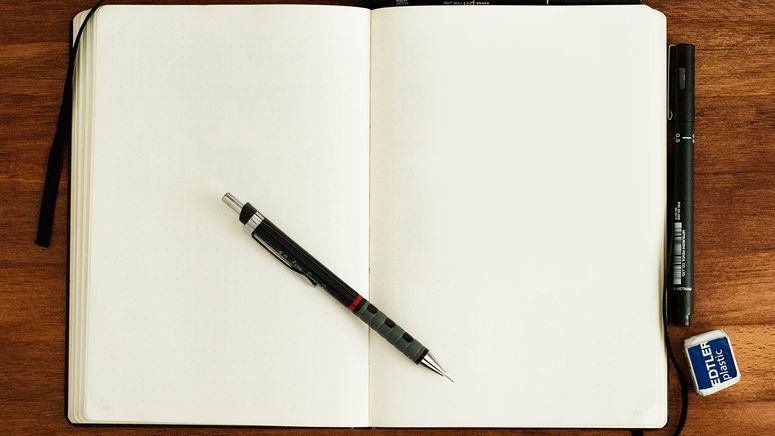 Photo of an empty note book with pencil and eraser