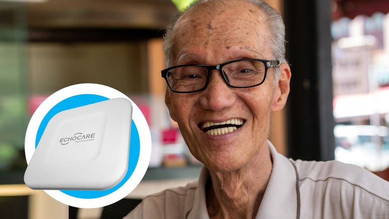 Photo of an older asian man smiling at the camera wearing glasses. There is an insert photo of the Echo device on the left of the image