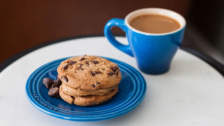 Is your loved one ready for care- photo of a blue coffee cup and bread plate. There are chocolate chip cookies on the plate