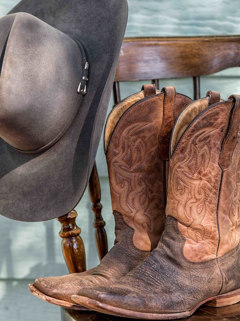 Old leather boots and Hat sitting on a chair at Lovess creek