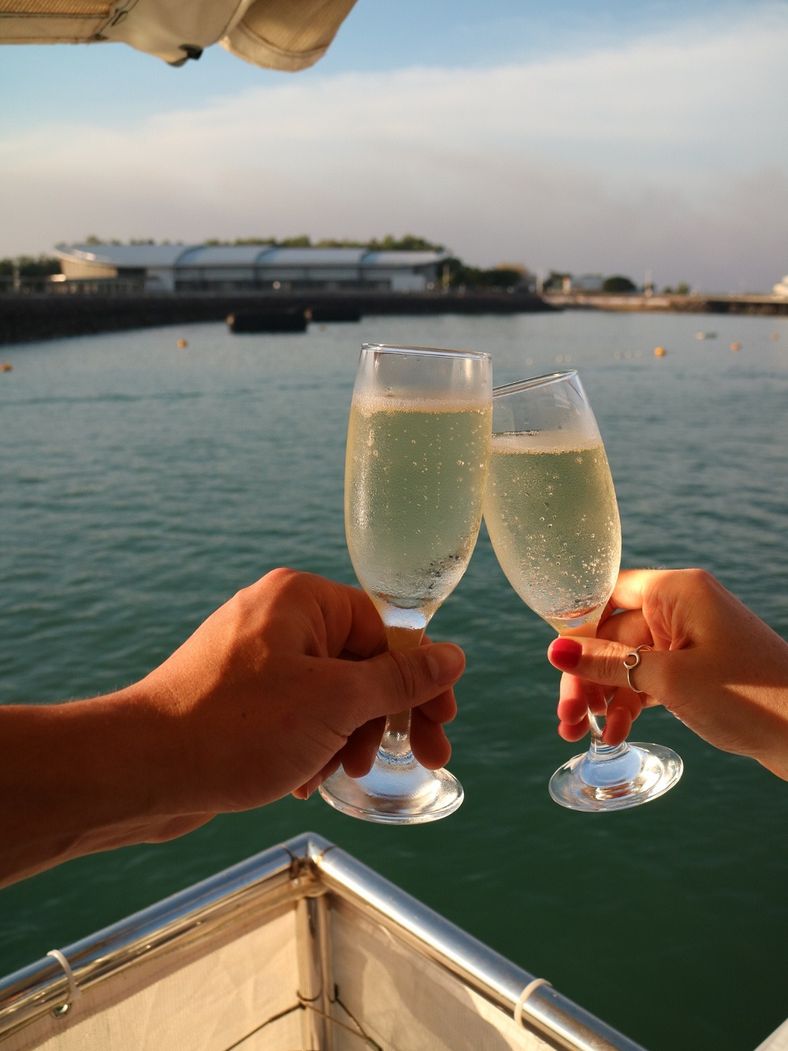 Couple sharing a glass of champagne on the Cape Adieu Harbour Cruises in Darwin