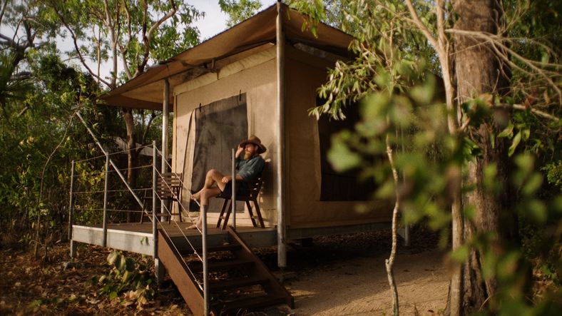 Man relaxing outside the safari tent