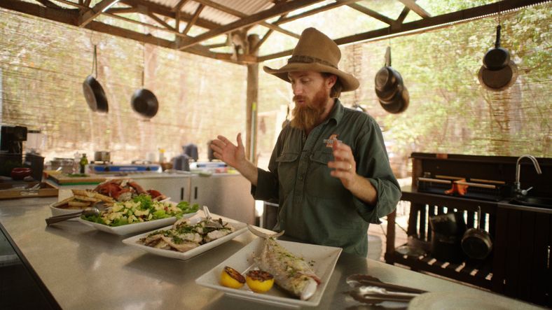 Guide serving Venture North tour dinner