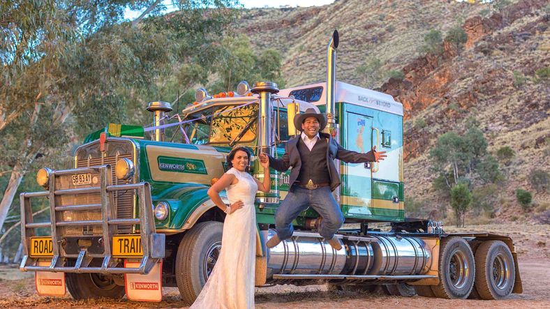 Tara and Jason posing on a truck