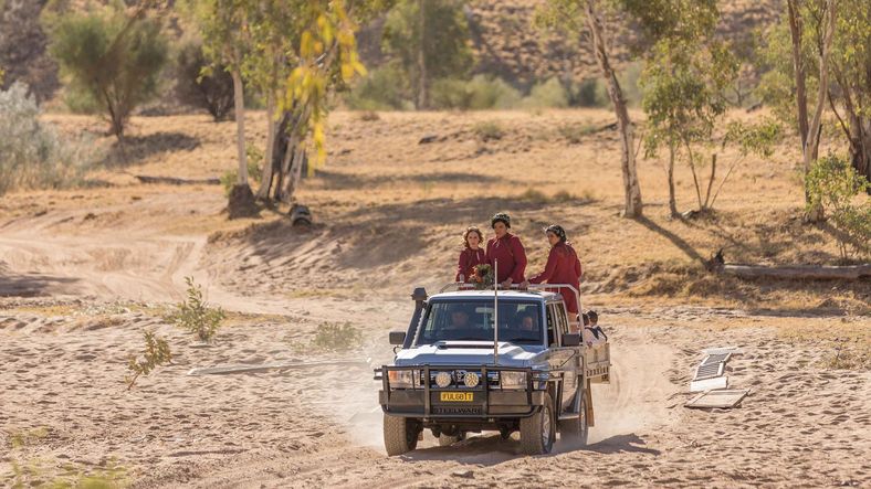 Wedding guests being driven to the location in a 4WD