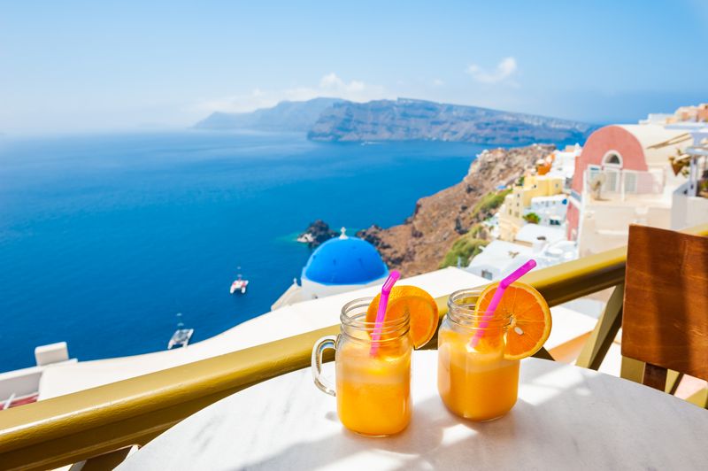 View from a resort in Imerovigli, Santorini, with orange juice on a table