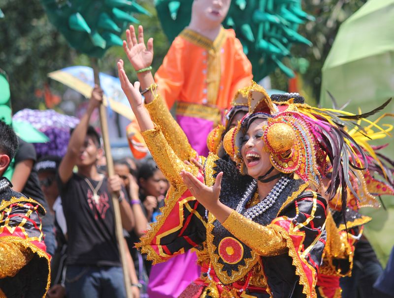Street dancers in colorful costumes at the Kadayawan festival