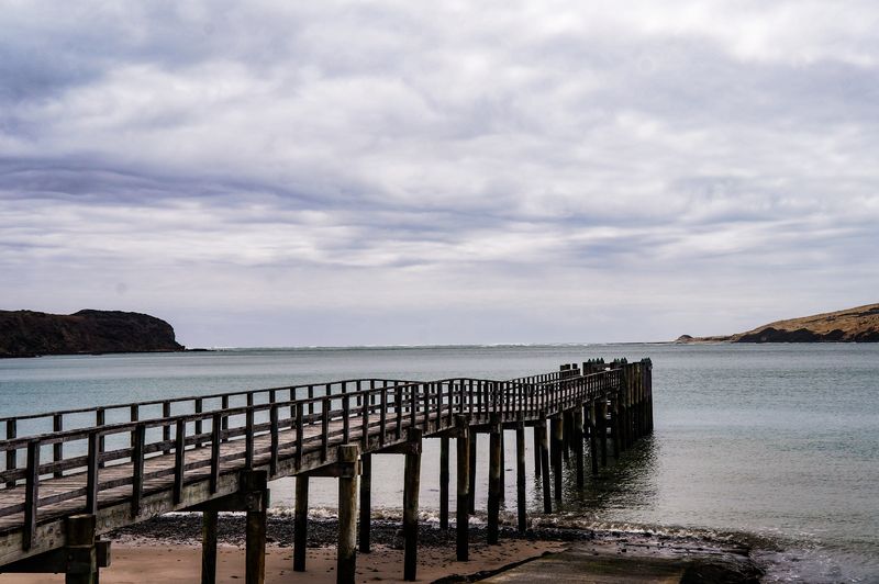 The wharf stretches out to the ocean in Hokianga