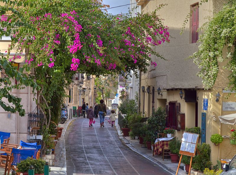 A pretty street in Plaka, Athens with a family walking in the distance