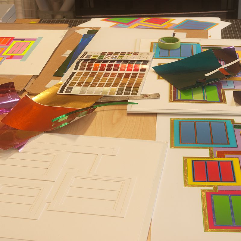 An assortment of print samples and colour swatches on a tabletop