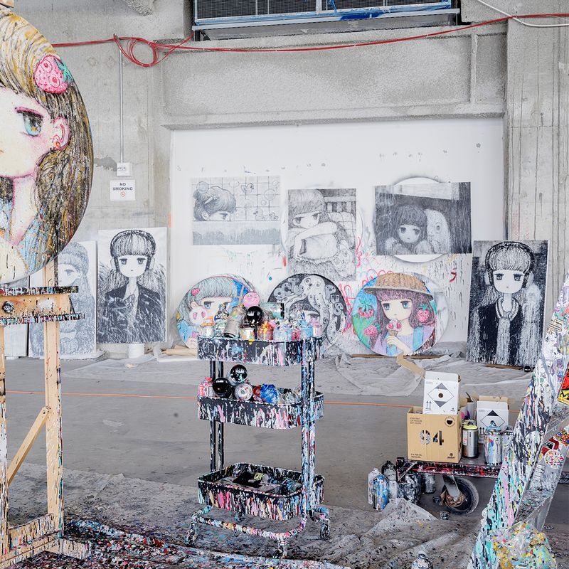 paint-splattered equipment and an array of canvases in Stickmonger's studio