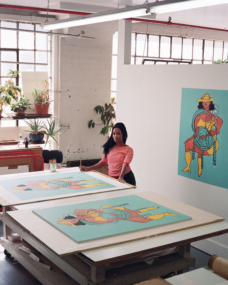Tschabalala Self with her prints in a brightly-lit NYC print studio