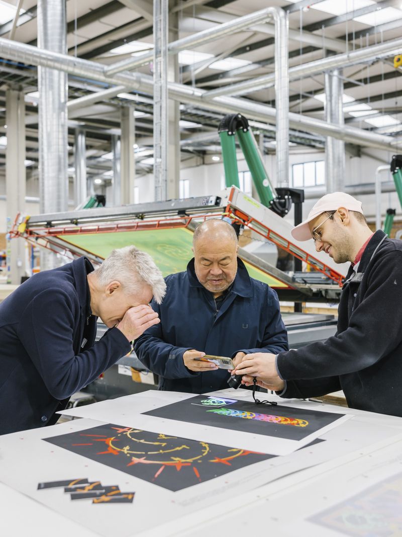 Tim Marlow, Ai Weiwei and a printmaker inspecting test prints