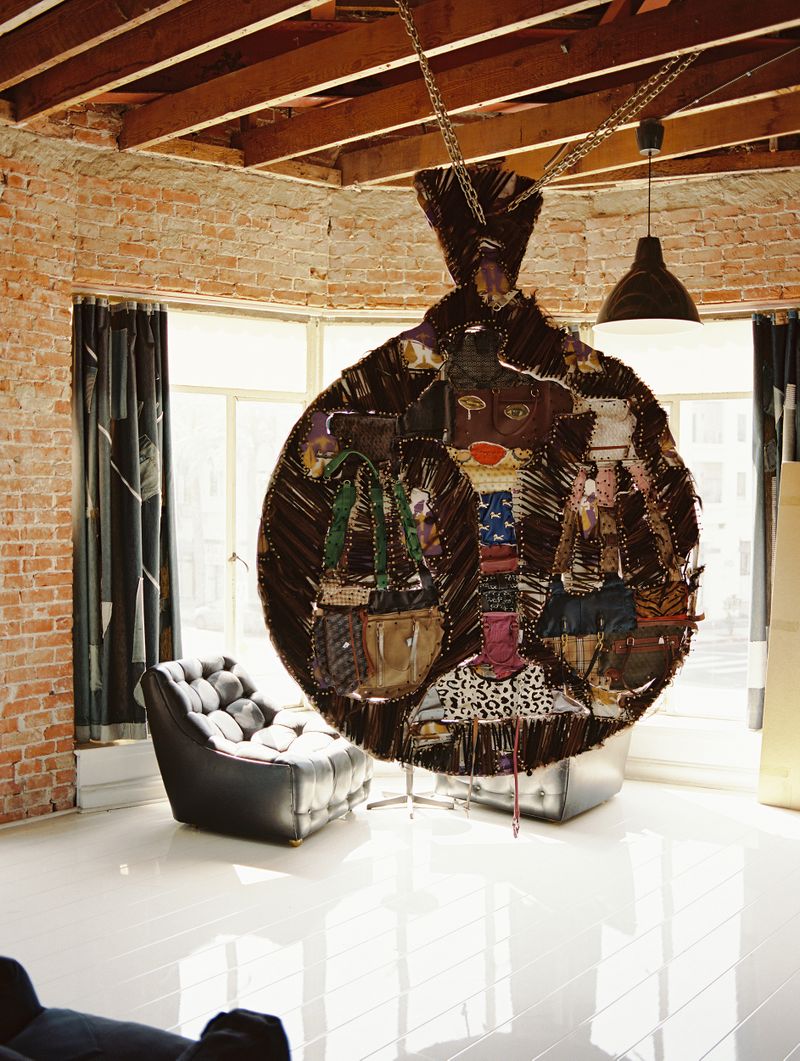 Interior of a Darren Romanalli studio showing a hanging piece of art in the middle