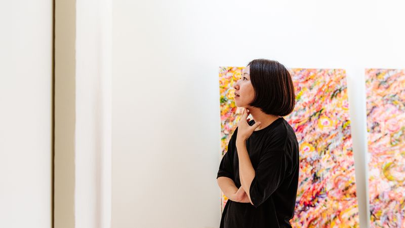 Ayako Rokkaku contemplating a blank canvas in her studio