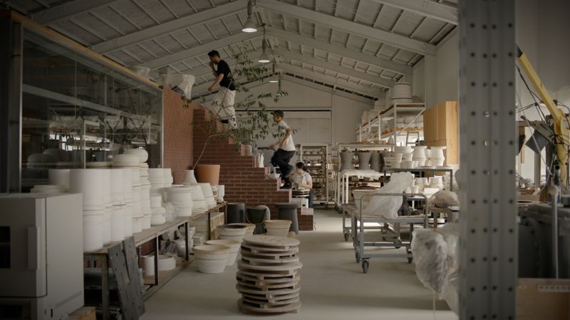 two artist climbing some stairs within a ceramic studio in Shigaraki 