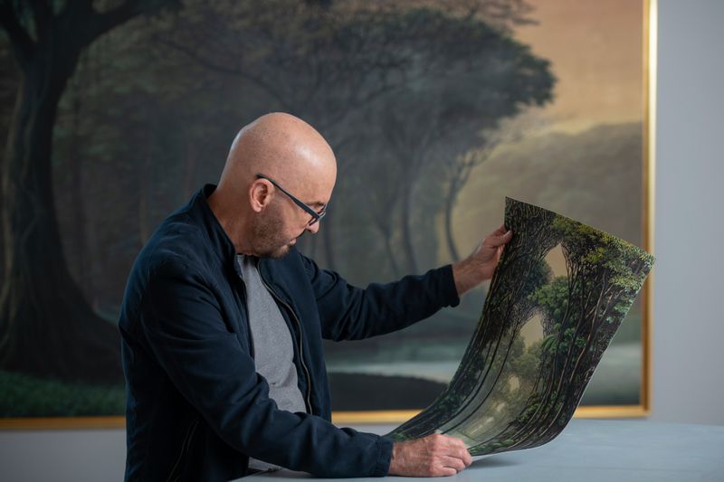 Tomas Sanchez inspects his print in his studio
