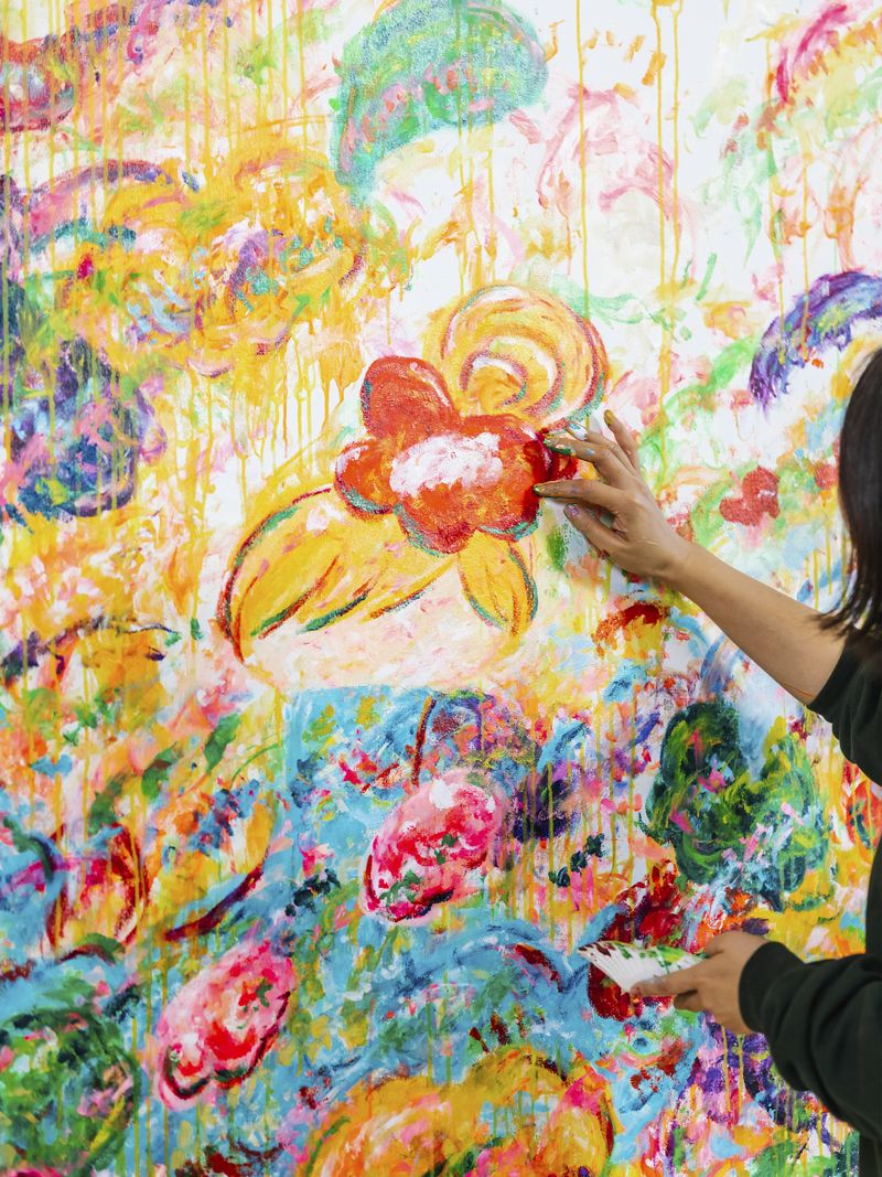 Ayako Rokkaku painting a red scrunchie