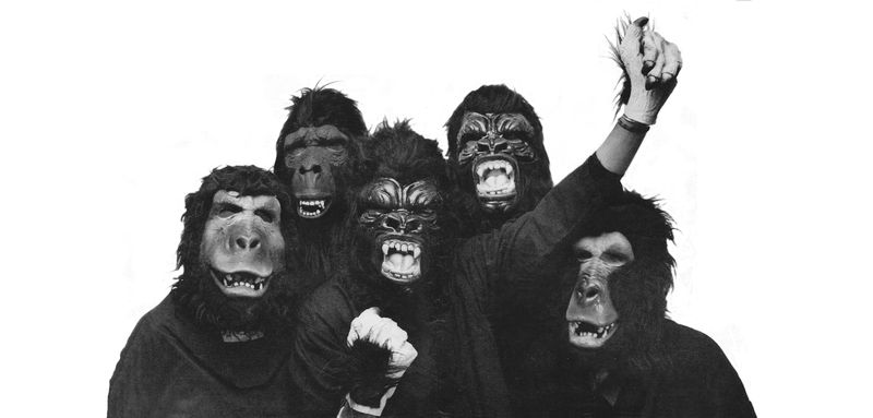 5 people disguised as gorillas, shot in black and white