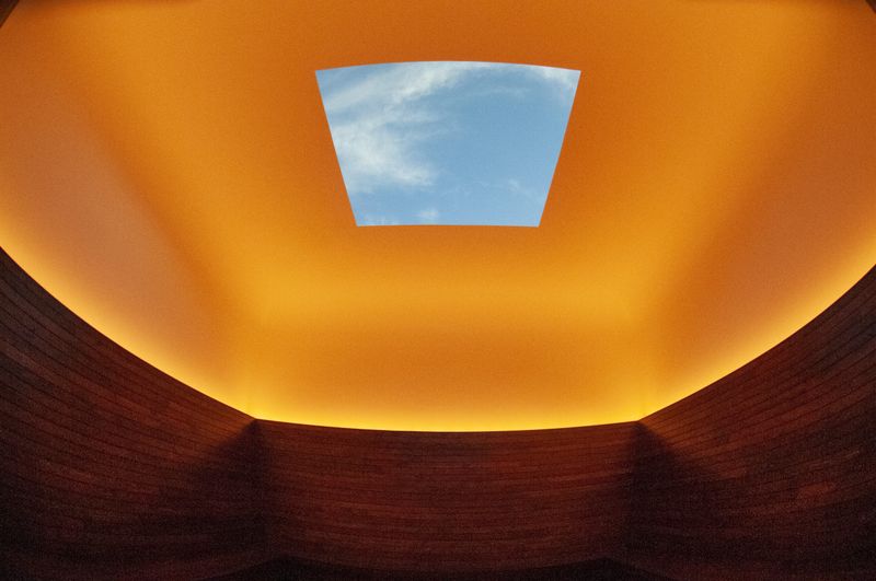 dramatic interior with a yellow ceiling and large square skylight