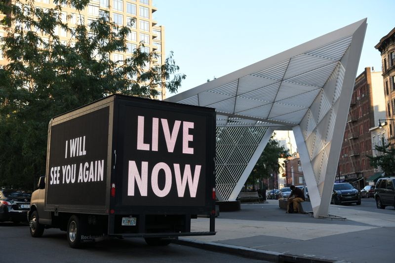 A truck with slogans standing on a street, Jenny Holzer - NYC AIDS Memorial