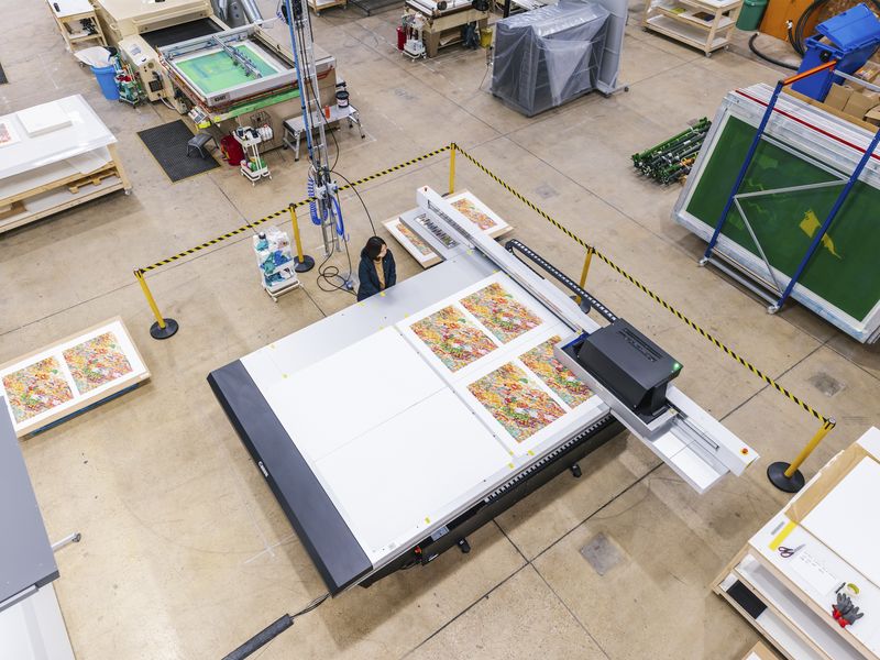 view from above of Ayako Rokkaku in an industrial printmaking studio