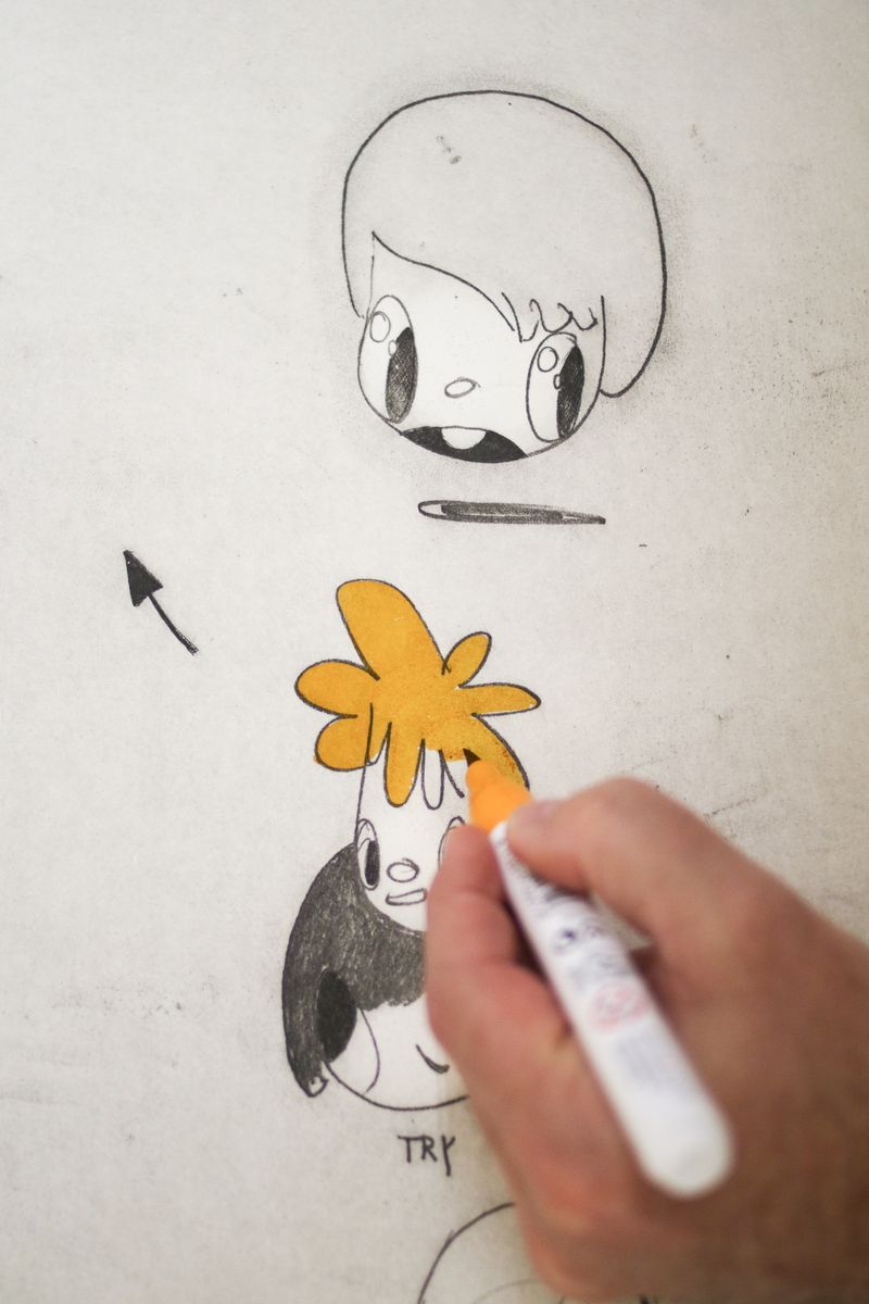 Artist Javier Calleja hand-finishing an artwork with a marker - close up detail