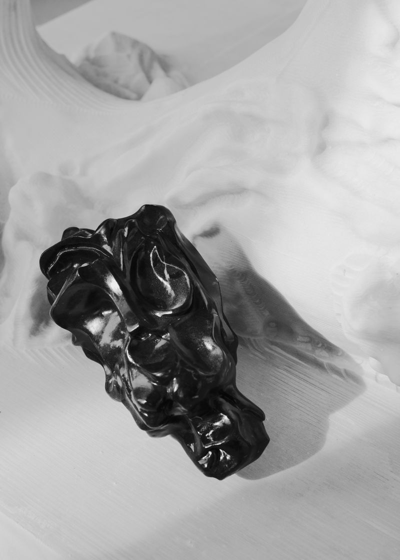 A close up of a black marble sculpture by Kevin Francis Gray