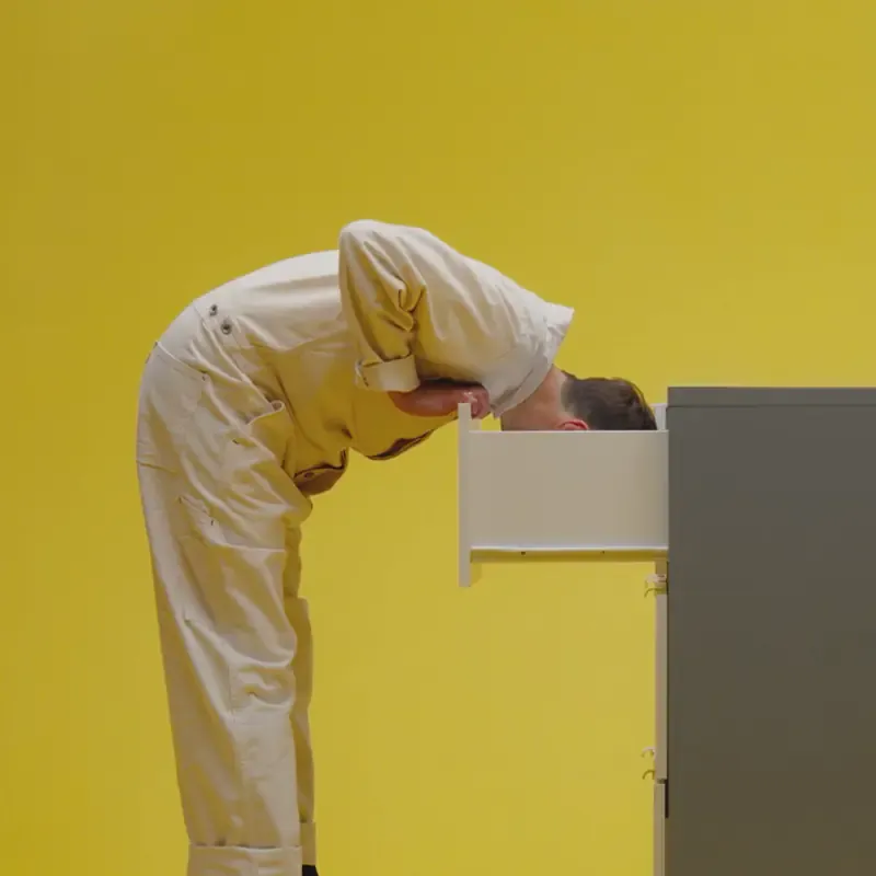 Person leaning head into a VISTHUS dresser drawer on yellow, from the Sound of IKEA campaign