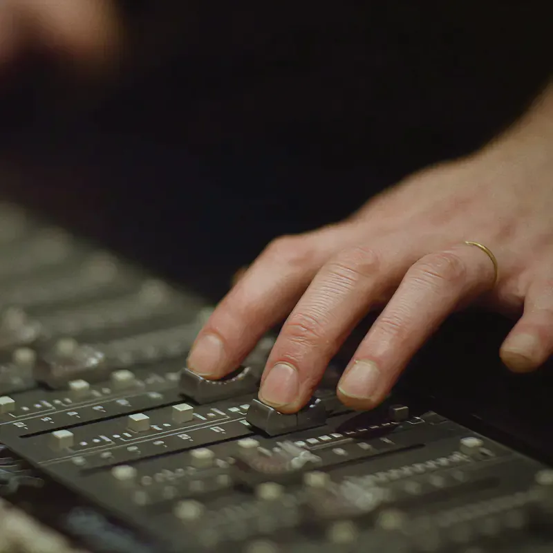 Hands of a sound engineer on a mixing desk, from the Sound of Leffe campaign