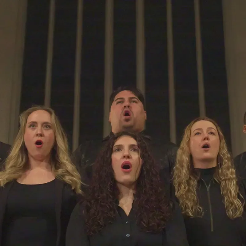 Choir singers performing and looking upward, from the Sound of Leffe campaign