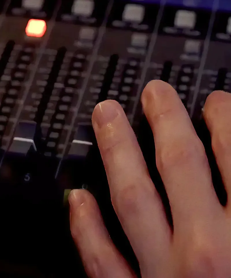Hands adjusting faders on a mixing desk, from the Sound of Samsung campaign