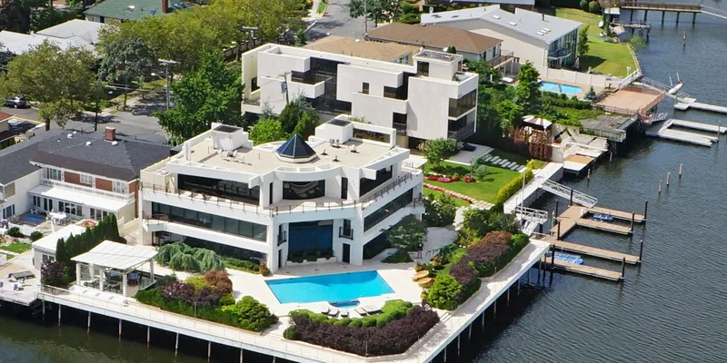 Aerial image of mansion in Mill Basin with pool and dock