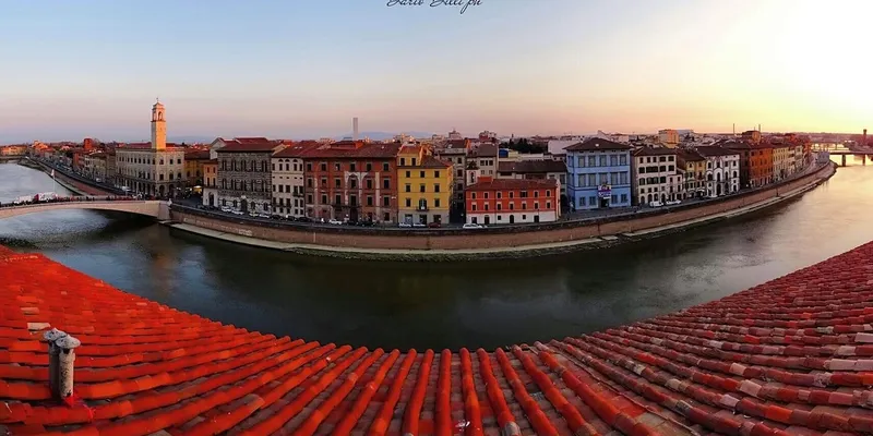 Pisa skyline view with Arno river at sunset