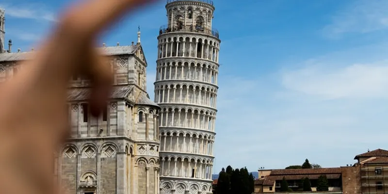 Leaning Tower of Pisa and with fingers in front of camera lens