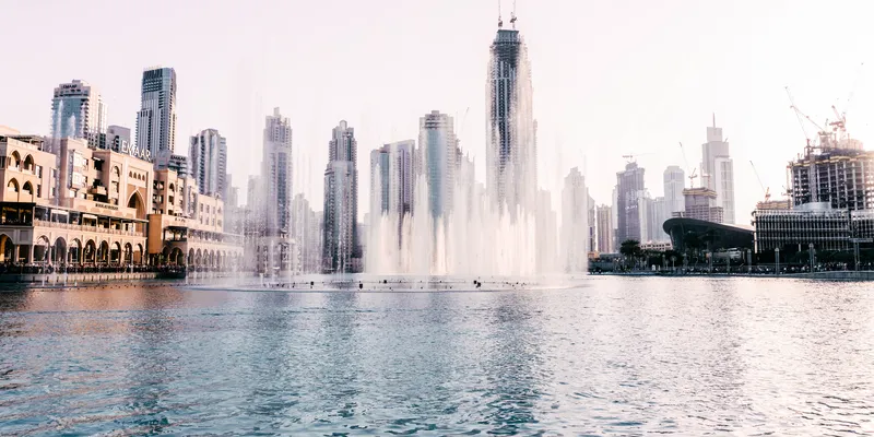 Dubai Fountain spraying water with Downtown Dubai skyscrapers in the background